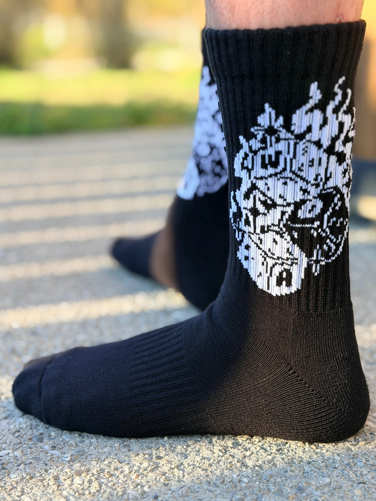 Detail view of Roll the Dice black riding socks with white design
